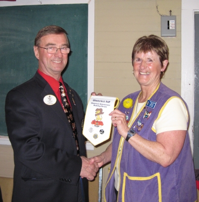 DG Bobby Dean presenting President Pat Parks with his Banner & Pin