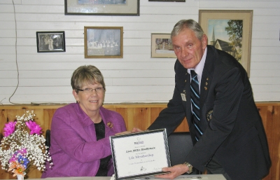 VDG Wayne Little presenting Lion Millie MacKenzie with Life Membership Lions Foundation of Canada