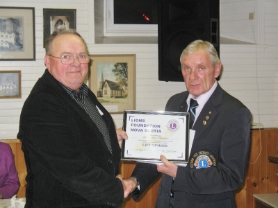 VDG Wayne Little presenting Lion Allan Chambers with Life Membership Lions Foundation of Nova Scotia