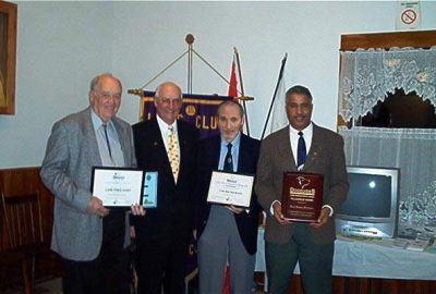 PDG Charles Uhlman presenting Lion Fred Hunt with Life Membership Award LFC, Lion Ken MacKenzie with Judge Brian Stevenson Fellowship Award and Lion Angus Johnson with Lions Foundation Canada Fellowship Award.