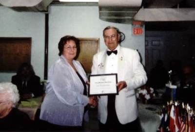 DG Ray Penny presenting Lion Maureen MacIsaac with Life Membership Lions Foundation of Canada