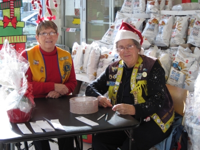 Lions Millie & Florence selling Christmas Basket Tickets