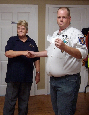 Lion Wendy Blue presenting a cheque to Hants West Ground Search & Rescue purchasing 2 Project Lifesaver Transmitter Bracelets
